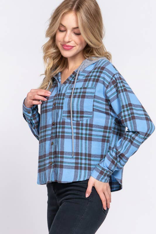 Woman wearing a blue plaid shirt on a white background